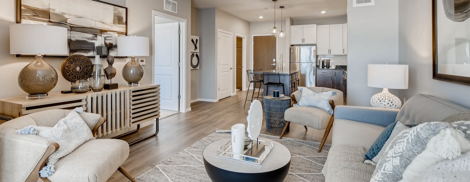 a living room with a couch, tables and chairs