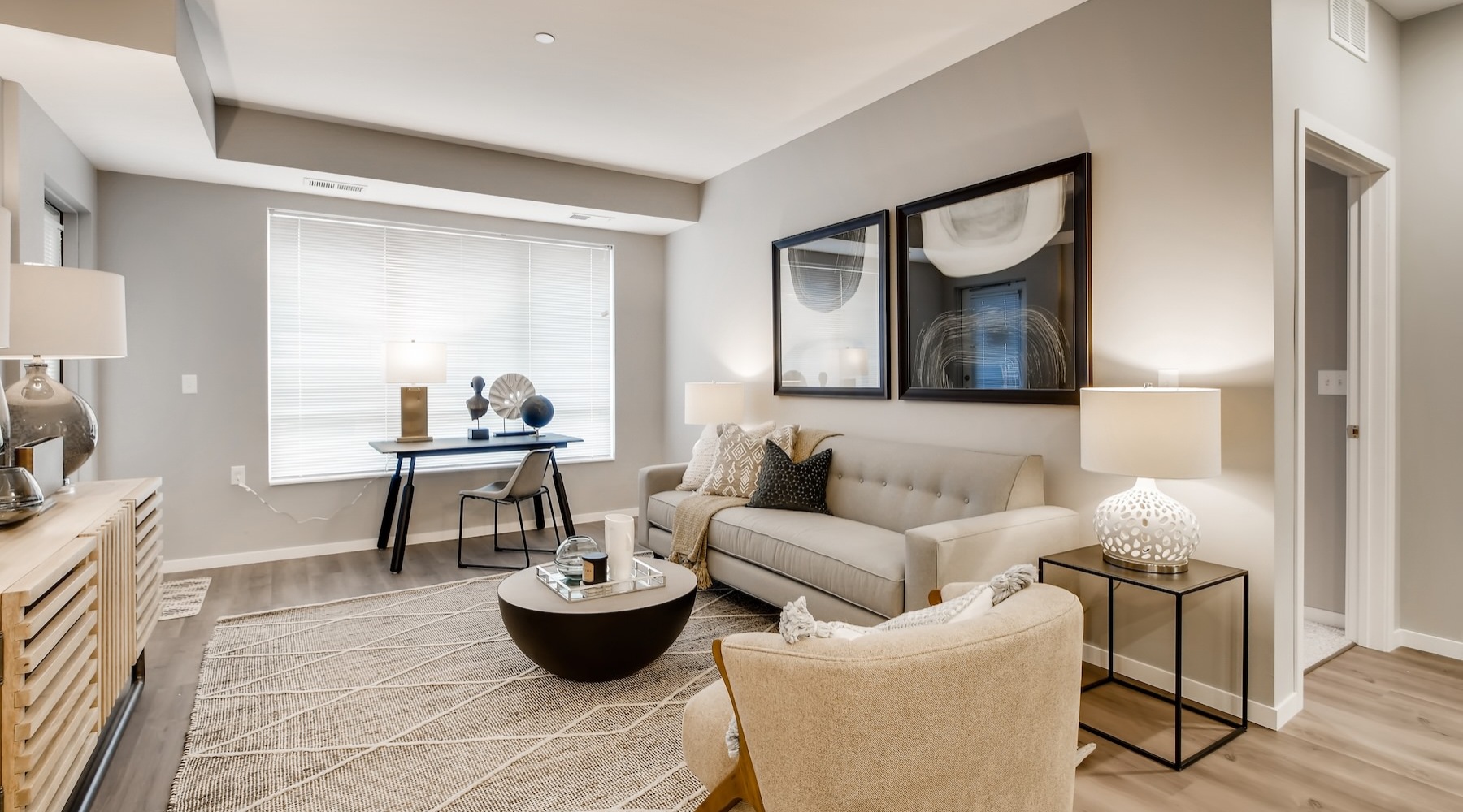 a living room with a couch, tables and chairs