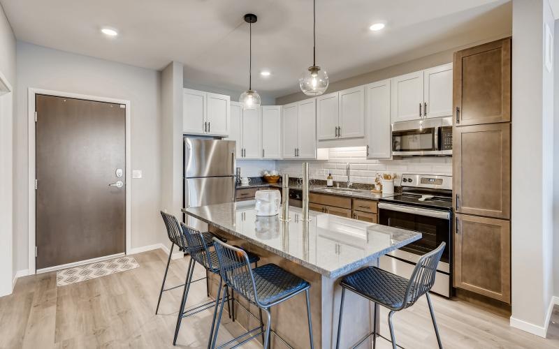 a kitchen with an island and chairs