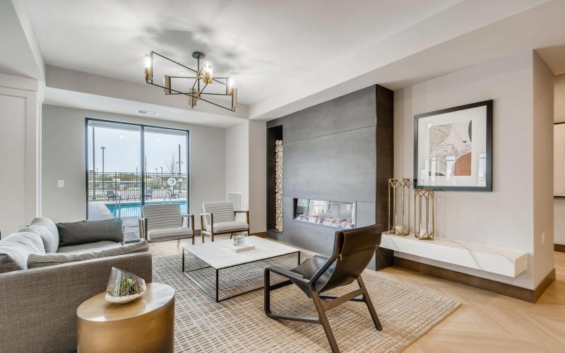a clubroom with a couch, table and chairs