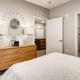 a bedroom with a bed and a dresser